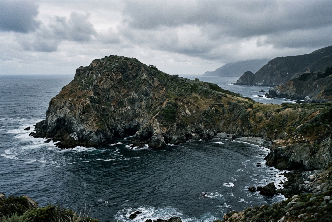 Rocky headland and protected coastal water on the California coast under low cloud